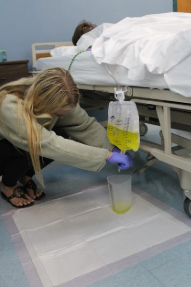 Nursing In Training: Senior Maddie McGrath from the PCA program practiced carefully emptying a patient’s urinary drainage bag into a measuring container in the hospital lab. Wearing gloves and using proper technique, she learned how to measure and record output accurately. This hands-on training helped prepare students for real-world healthcare situations. The activity took place in the nursing lab, which was designed to simulate a hospital environment. McGrath said, “Some key features and benefits of the nursing program included hands-on patient/clinical experience.” Through experiences like this, students gained the confidence and skills needed to care for future patients. Photo by Renna Petrides