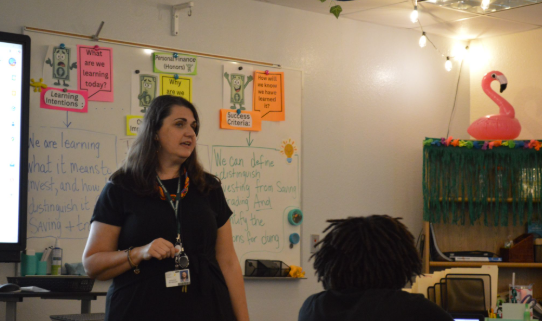 Engaging Students in History and Finance: Mrs. Monique Reynolds talks to her students during a world history lesson. As a new teacher at Melbourne High School, she worked to balance being approachable and disciplined and encouraged students to give feedback to improve her teaching. “I teach three classes of personal finance, which are mostly sophomores, and world history, which are all freshmen,” Mrs. Reynolds said. By combining her passion for history and personal finance, she helped students understand the importance of learning from the past while preparing for the future. Photo by Aadhya Patel.