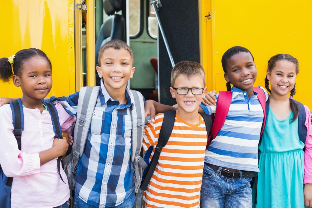 school children in front of school bus