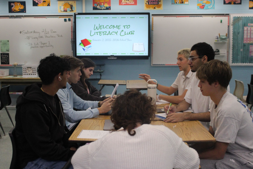  Literacy Club Inspires Students. The Literacy Club gathers to plan lessons and mentor younger students in reading. The club quickly became one of the most meaningful new clubs, giving high schoolers the opportunity to help younger kids learn. Club sponsor Ms. Courtney Boos encouraged students to make a difference for the community and themselves. “The students meet every Monday and Tuesday before school in my room.” Ms. Boos said. Photo by Jamie Reynolds. 