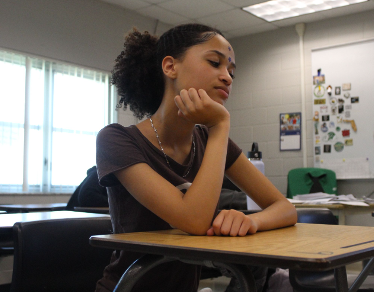 Caption: Focused during class time, Jill Farrell listened closely to the lesson by Mr. Woodbury during class, while he talked about the upcoming exam.“well organized and keeping a planner” Farrell said to stay prepared. She feels ready and is staying organized for the exam. Photo by: paige allen