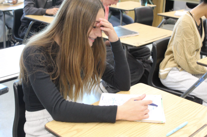 Notes and new beginnings: Freshman Autumn Rose focuses on taking notes during Mr. Woodbury's lesson, understanding and learning. “Taking good notes and being organized in this class is the most helpful” Rose continues to stay focused and on a good track in AP World HIstory.  Article by: Paige Allen Photo by: Paige Allen