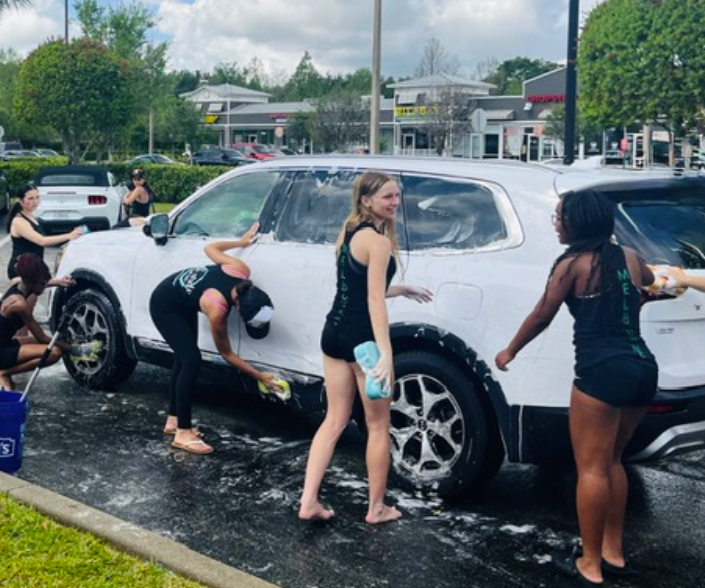 Miracles Host Car Wash Fundraiser At Long Doggers: Kamiyah King, a Miracles dance team member, helps at Miracles’ car wash at Long Doggers to raise money for new uniforms and competition fees. The group worked together throughout the morning from 7am to 11am, washing cars and engaging with customers while promoting their cause. They raised a total of $699 through their efforts and community support. “I’m beyond excited! I’m so ready for what’s upcoming this year!” King said. Photo by Issy Perez.