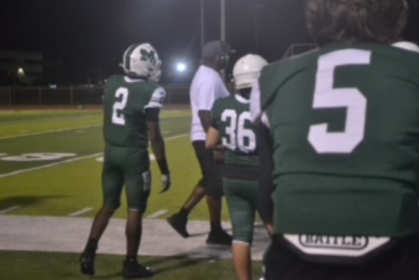Tyquez Harris stands on the field during a JV matchup, focused under the bright Thursday night lights as his team battles for a win. Behind the action, hours of practices and preparation have led him to this moment. Clearly, his determination and consistency are key to his performance on the field. Determination keeps him pushing forward, even when the season demands long practices and late nights. Harris says, “It takes a lot of determination and fails to get to this point, never give up on something you love.” Questions remain about how far the team will go this season, but Harris’s drive is already leaving its mark. Photo by Anabella Mulligan
