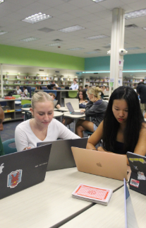 Planning Ahead: Seniors Joy Weng and Chloe Martinez fill out the culture fest interest form. Every other Friday during 5th and 6th period, students from across the IB program and ESOL classes met in the library to discuss their plans for culture fest. On the interest form, students chose what countries they wanted to represent and what committees they wanted to be a part of. Weng signed up to be in the group for China and the talent show committee. “The talent show is my favorite part of culture fest, so I want to be part of organizing it,” said Weng.  Photo by Kyra Chang
