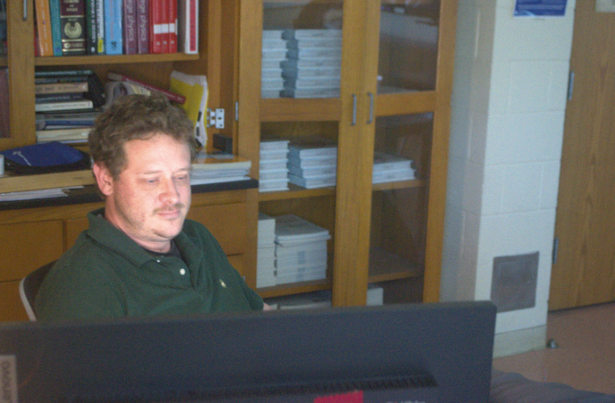 Preparing for more in Physics: Mr. Proctor at his desk planning out the next courses his students will learn as the school year approaches an end. Mr. Proctor recently concluded teaching his student’s optics, and has planned to educate them on some complex yet fascinating parts of the universe. “We only really have four weeks of teaching stuff, since I want the last few weeks to be about reviewing things for the exam… If we have time, we might do photons, quantum stuff, maybe geology? But probably not since it’s a bit much for what we have time for.” said Mr. Proctor. Photo by Tyler Ferreira Alves Hill.