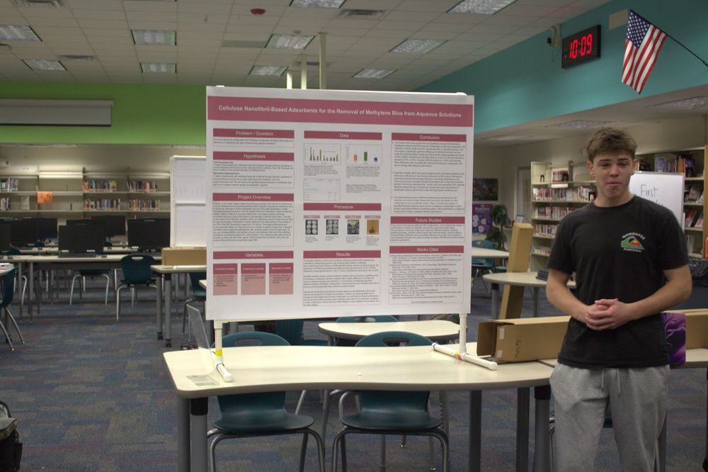 Caption: Evan Mellor shares his science fair project. Photo by Emani Morgane