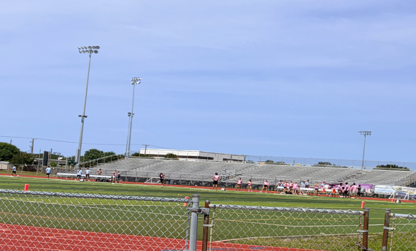 SWAP ON THE FIELD: Melbourne High seniors prepare and organize on the field before the PowderPuff game. The Powder Puff Game took place on Wednesday afternoon at Melbourne High. The junior class defeated the senior team by 32-6. “It was so much fun being on the sideline and watching the game” said Cameruci.   Photo by Jayda Blanc 