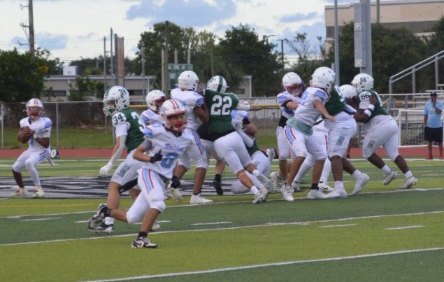 Between The Lines: The stands are packed, the crowd is loud, and the Bulldogs Fight hard under the lights tonight. The JV team shows grit and teamwork from the first whistle to the last play tonight The team has been practicing hard all week, running drills, studying plays, and pushing each other to improve, which pays off on the field tonight. Sophomore lineman Mark Perry has been playing football for nine years and takes on both sides of the line. “Playing both sides of the line is tough, but it helps me understand the game better. I know what the defense is trying to do and what the offense needs from me,” Perry says. His teammate and brother, Alex Perry, credits their coaches for the lessons that go beyond football. “The coaches always push us to focus on the little details. It’s not just about strength; it’s about footwork, timing, and being disciplined every play,” he said. The Bulldogs may still be learning and growing, but their effort shows they’re ready to make this season one to remember. Photo by Lily Majors