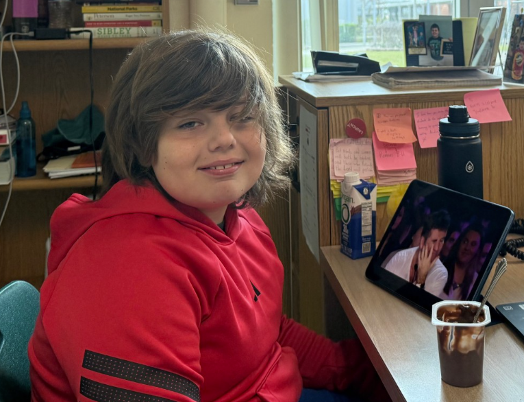 Future Bulldog: Henry Dale sits proudly at his father’s desk as Mr. Timothy Dale teaches his English 3 class during “Take Your Kid to Work Day” on last Thursday. After exploring the differences between high school and his own elementary school, Henry felt like a true member of the staff thanks to a special souvenir from the main office. “Ms. Toll made an ID badge for him. He was very proud of that,” said Mr. Dale. Physics teacher Mrs. Laura Zamora likewise shared the day with her family, experiencing a high-energy classroom environment with her own children. “Everyday when I leave the house to come to Mel Hi, they chase me down and ask me if they can come,” said Mrs. Zamora. The visit served as a memorable first for the Dales, who enjoyed the rare chance to spend the school day together. “He loved it! He was super excited about it,” said Mr. Dale. Photo by Mr. Dale