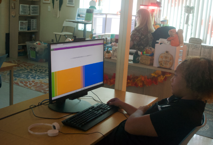 Caption: Teaching Through The World: As a new freshman high school student, Ava Gabriel approaches her Booklet practice test with confidence and determination. Melbourne High School has one Digital Tech class and teacher, Denine Chang. Ava Gabriel showed not only her focus but also the passion for learning new digital tech skills. “Digital Tech has been nothing but a great experience and learning new things”, said Gabriel. Photo credit by Jayda Blanc