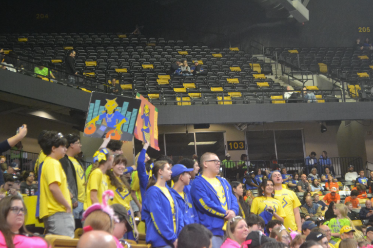 Caption: TEAM SPIRIT. Team Voltage celebrates their team by doing their cheer and holding posters of  their mascot up. Melbourne High School robotics team went to Orlando for the FRC robotics regional and got to semi-finals. “I believe our teams biggest strength is our spirit and how we work together as a team”, Manuel Castillo said. Picture by Melissa Amaro.