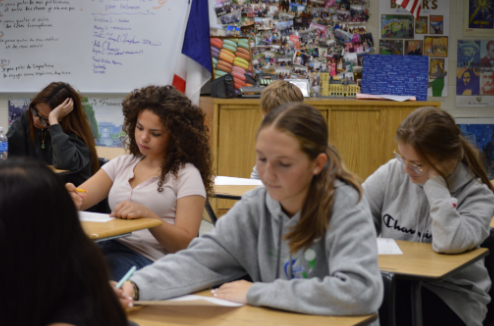 Testing through the World: As a new freshman high school student, Emily Lemons approaches her French test with much courage and dedication. Melbourne High School has one French teacher, Madame Courtois. This school year will mark her 24th year of teaching French. Emily Lemons shows not only her focus but also her passion for learning a new language. “Taking French this year has been nothing but great adventures and new experiences” said Lemons. Photo credit by Jayda Blanc