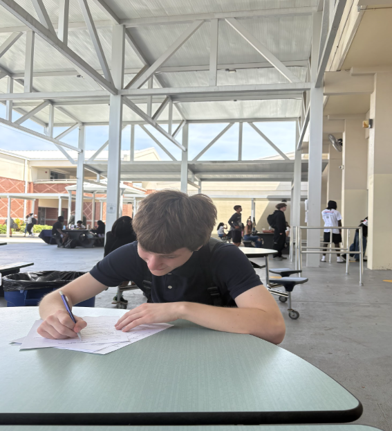 Ethan Dennison, an 11th grader at Melbourne High School, fills out paperwork to apply for the school-to-work program, taking an important step toward balancing classes with future job experience. As he completes the forms, he reflects on how the opportunity could shape his future and build responsibility. Dennison says the program is “going help me prepare for going into work full-time and learning important skills like time management.” He adds that staying consistent matters, explaining, “Being on time and prepared has been one of the biggest things I’ve learned so far.” Photo by Hunter Paige