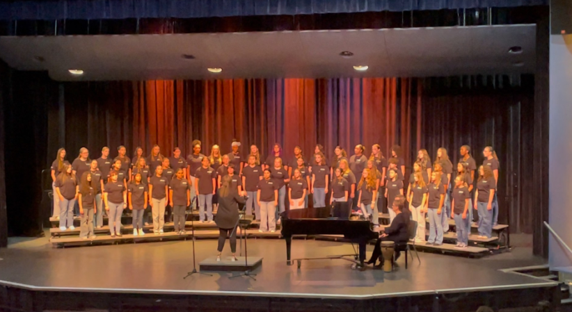 Caption: Feel The Music: Singing a hymn, the choral ensemble of Melbourne High School gives an excellent performance and showcase of their singing talents and abilities while being conducted by the Director of the Chorus program here at Melbourne High School, Natalie Harris. Junior chorus student Drew Smith stated that he really enjoyed the concert, “It was a grand old time”.   Photo By: Aiden Kehayias