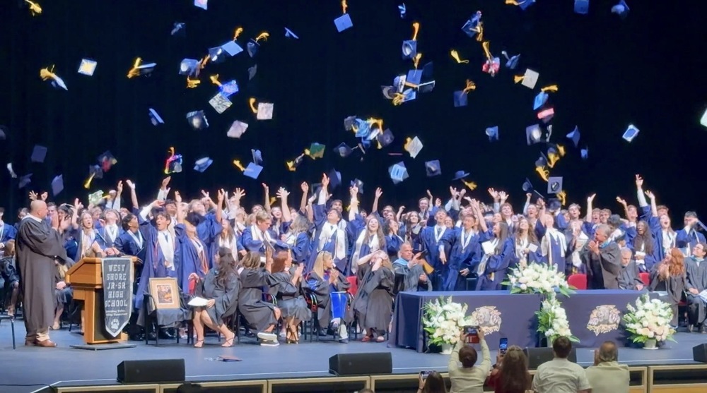 West Shore seniors tossing caps after graduation ceremony