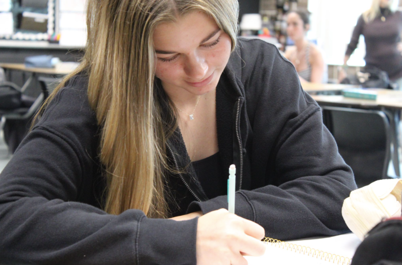 LEARNING THE WAVES: As a new freshman at Melbourne High School, Kenley Harris approaches her Marine Science Notes with encouragement and convection. Melbourne High has several teachers who teach Marine Science. Kenley Harris showed not only focus but hard work for learning about the new topics in Marine Science. “Protect all kinds of Marine Science life and help people make better choices on our environment”, said Harris. Photo by Jayda Blanc
