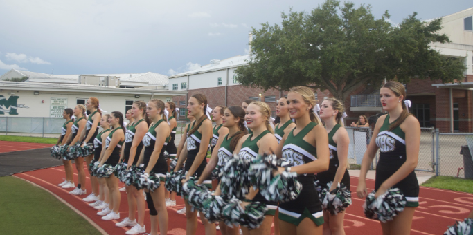Lets Get Fired Up!: Spirited with much enthusiasm and dedication, sophomore, Kodi Pennington celebrates the victory touchdown with her teammates on the sidelines. Melbourne High School JV Football team has kept a winning record of 5-0 throughout the season. With an extended rain delay, Melbourne JV conquers many touchdowns which leads Melbourne JV Cheer to spirit and encourage them to score more. “Whenever we score a touchdown, I feel excited that we are in the led but a little down for push ups” Pennington said. Photo by Jayda Blanc 