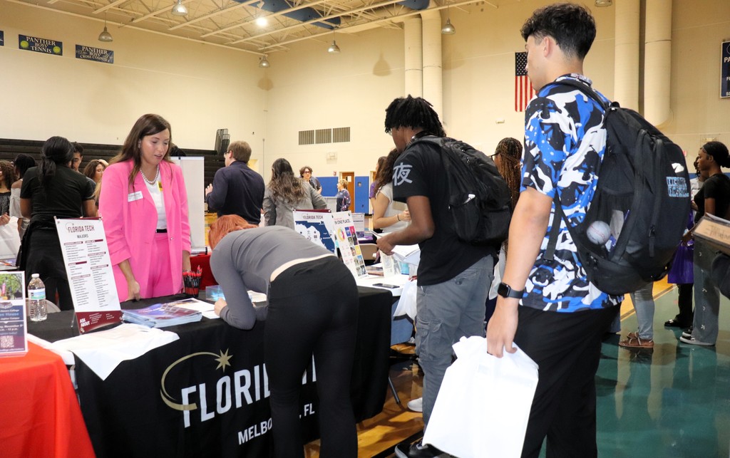 Students speaking with a college representative. 