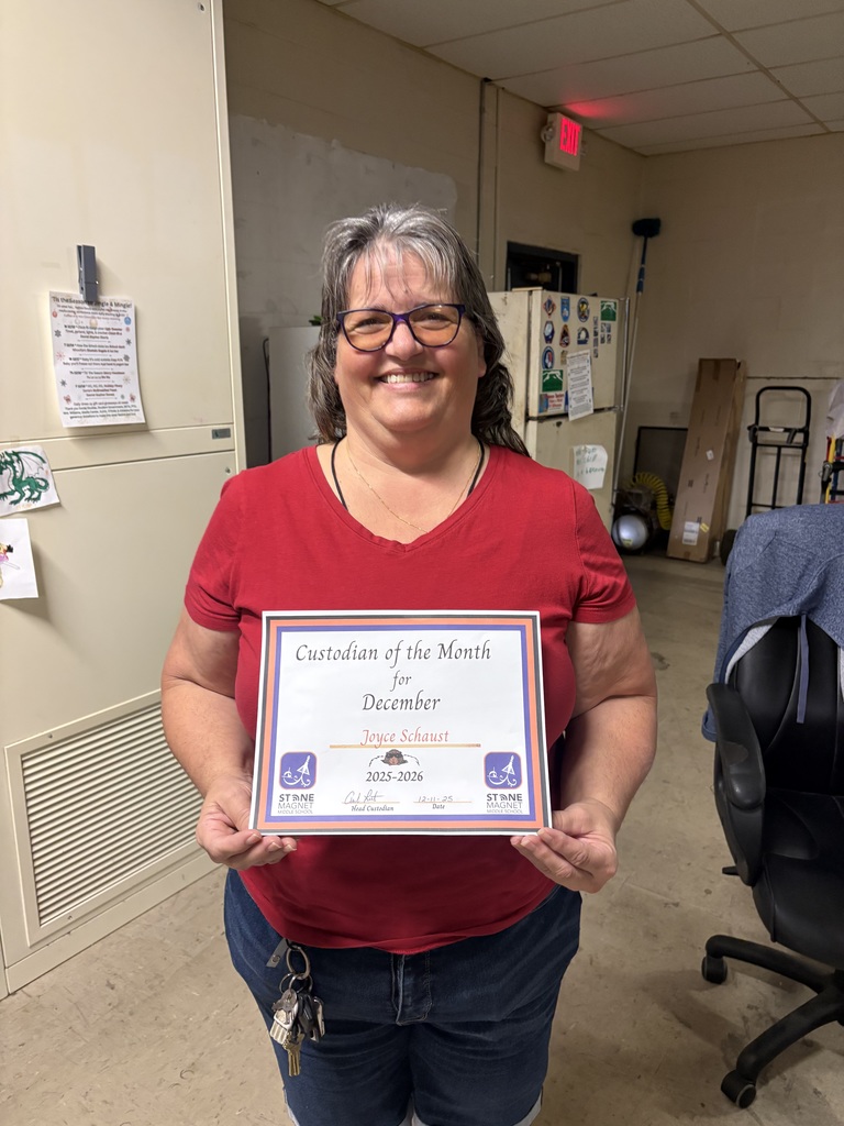 image of joyce schaust holding a certificate for custodian of hte month for december