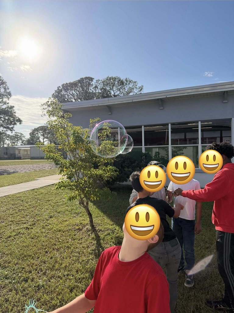 student showing off their bubbles created by their bubble wand made with 3 Doodler 3D pens
