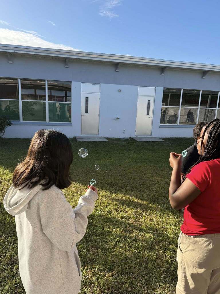 student showing off their bubbles created by their bubble wand made with 3 Doodler 3D pens