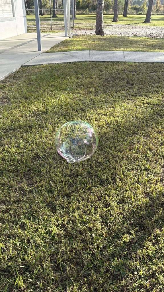 student showing off their bubbles created by their bubble wand made with 3 Doodler 3D pens