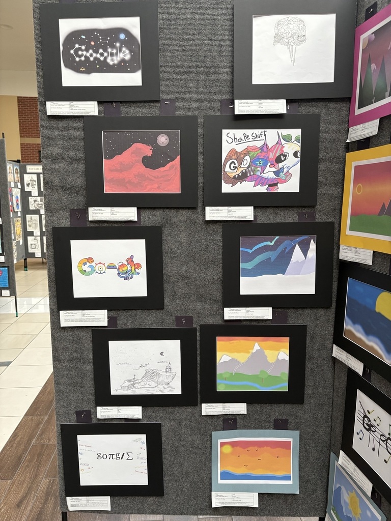 image of a display board with various student artwork pinned to it. 