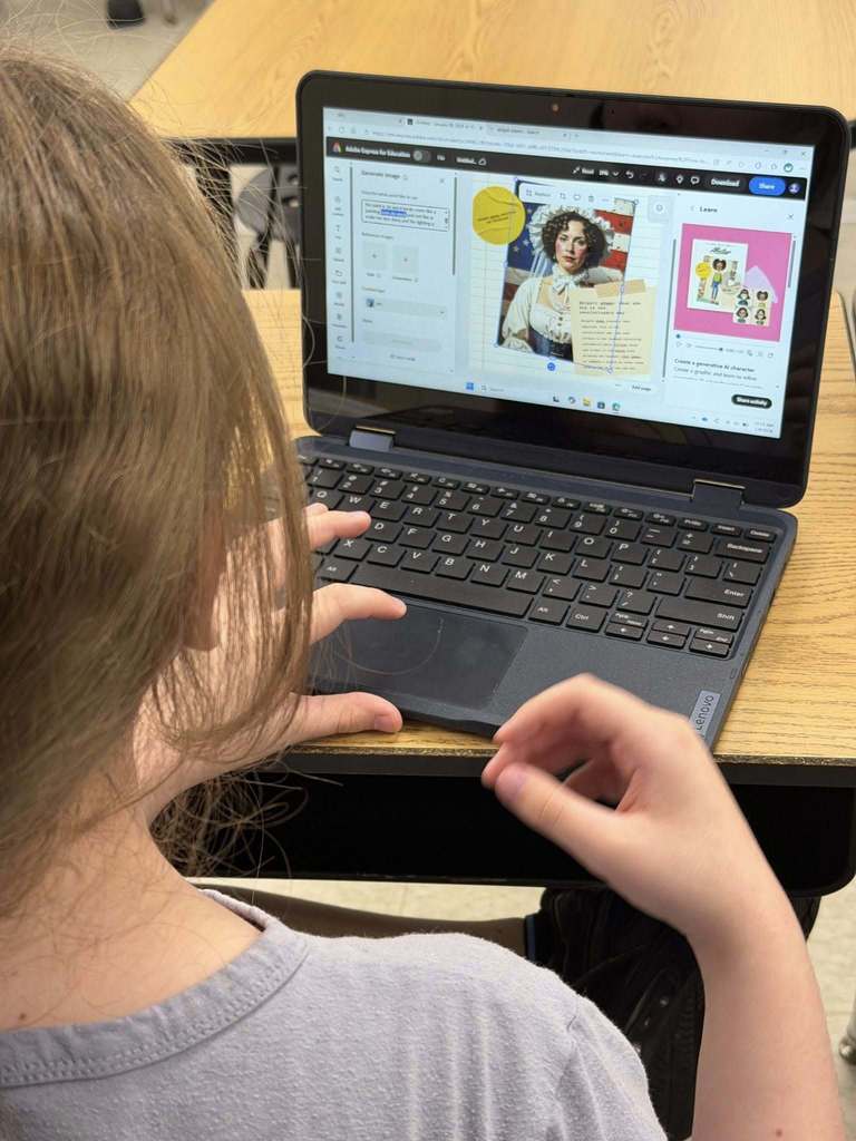 Students sitting at desks with laptops using Adobe for Education Express as a tool to show their learning