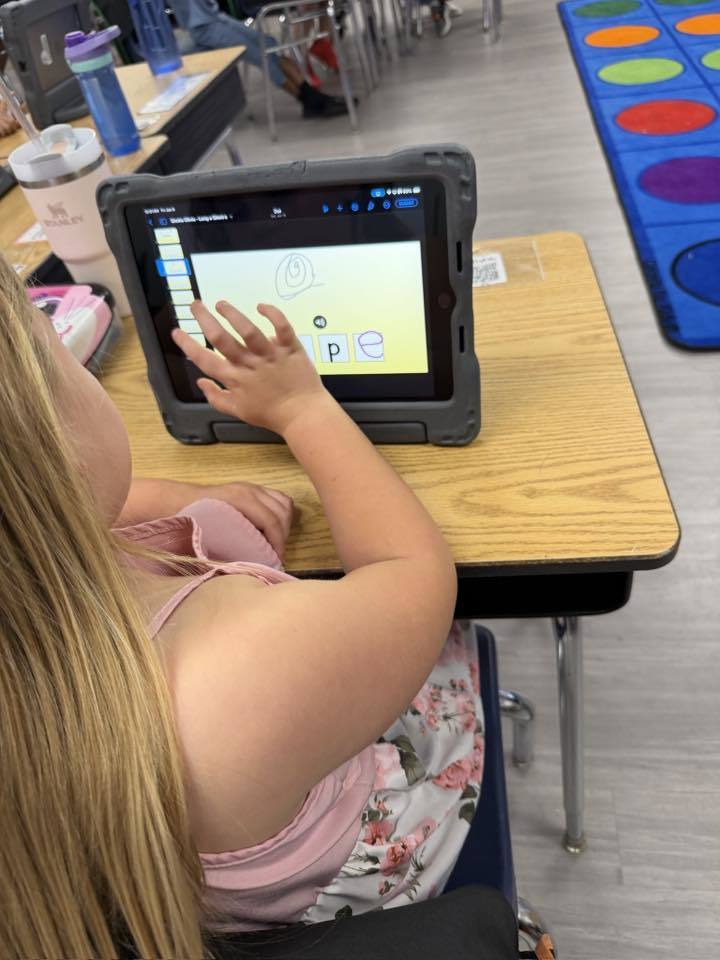 Students using iPads to practice 'Long A' and 'Magic E' 