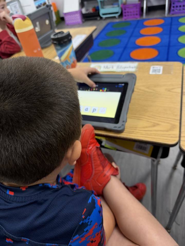 Students using iPads to practice 'Long A' and 'Magic E' 