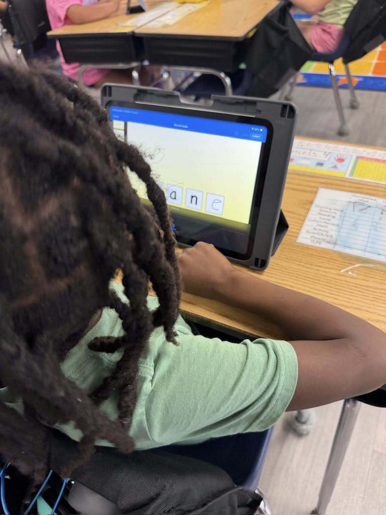 Students using iPads to practice 'Long A' and 'Magic E' 