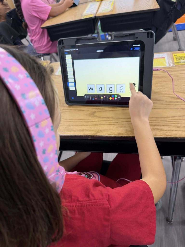 Students using iPads to practice 'Long A' and 'Magic E' 
