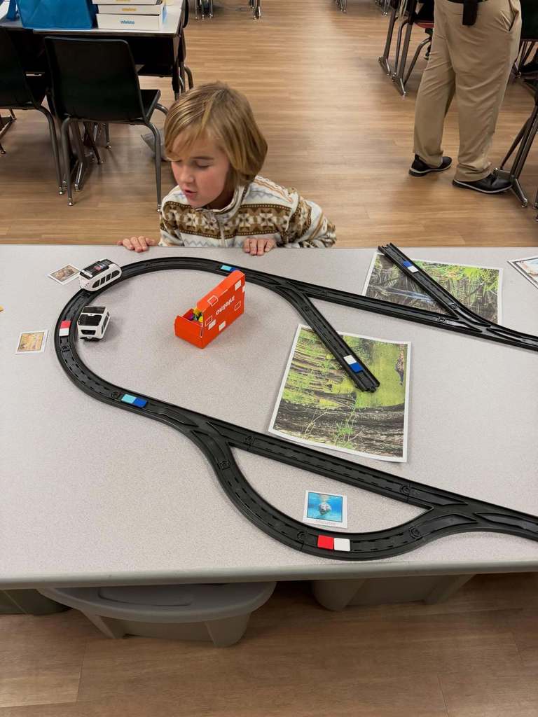 A student watching the train robot on the track
