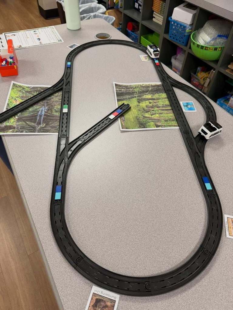 A train track containing color codes for the little robot train to perform activities