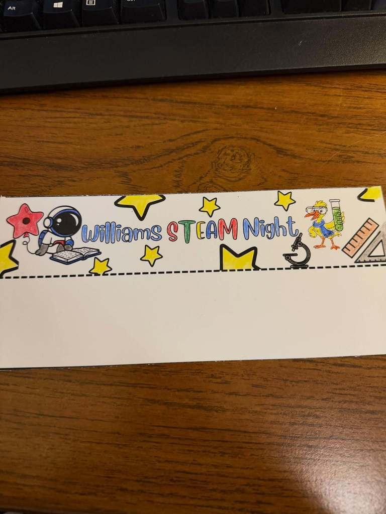 A colorful banner students created to welcome people . It says, "Williams STEAM Night"