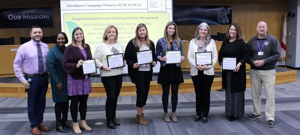 image of principals holding attendance champion awards in the bps board room 