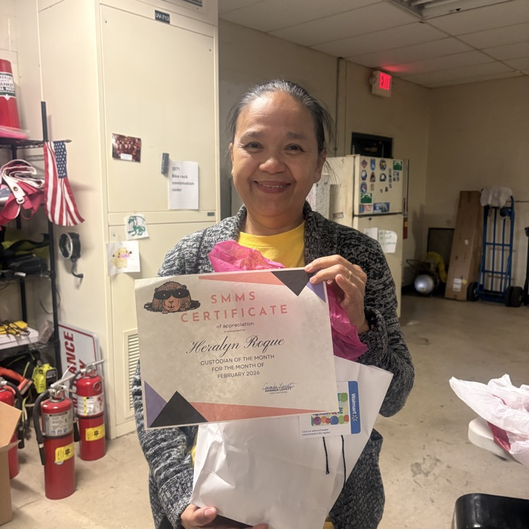 custodian holding certificate and goodie bag