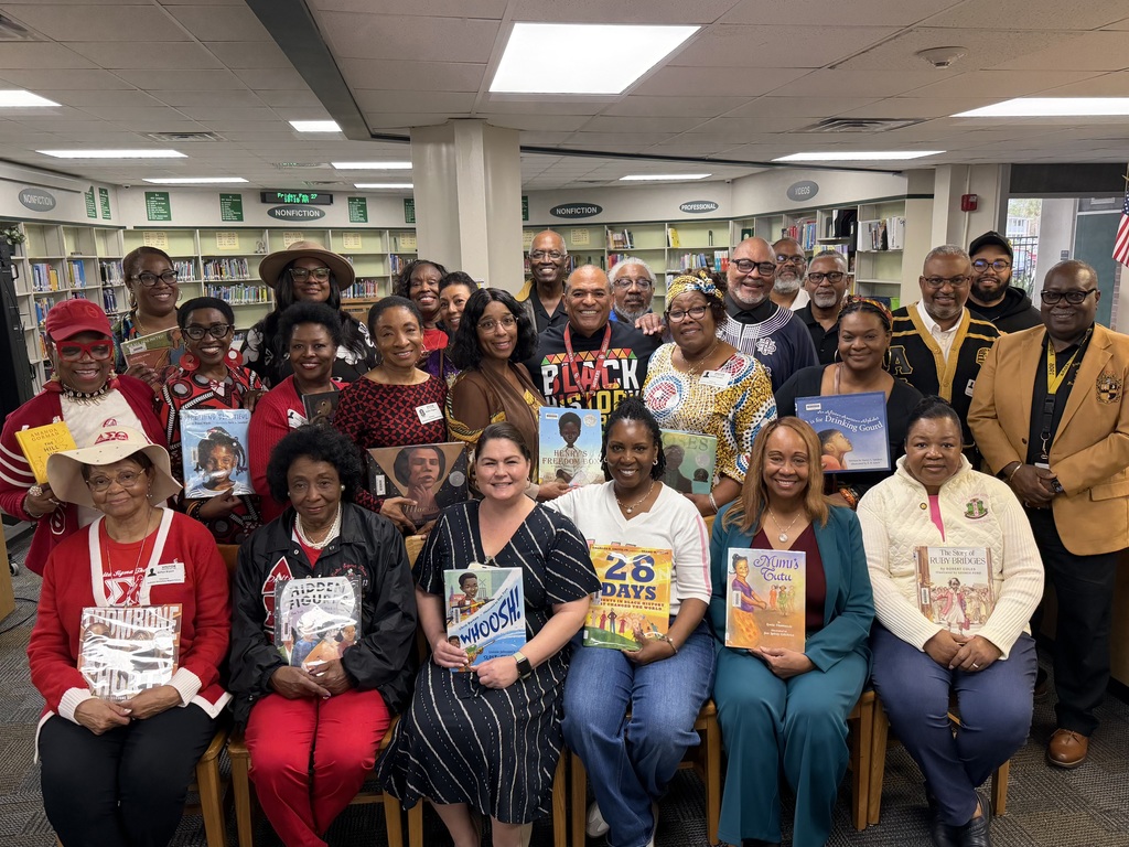 Group of adults holding picture books.