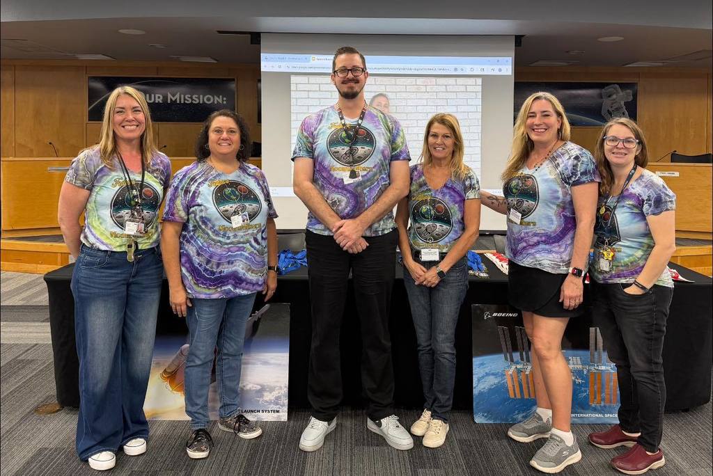 members of the Destination Moon team showing off their tie dye shirts