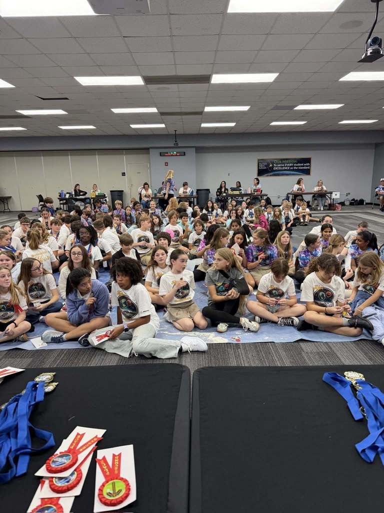 All student participants sitting on a giant map of the moon waiting for the presentation of awards