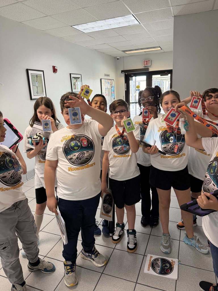 A group of students holding up their homemade moon trinkets