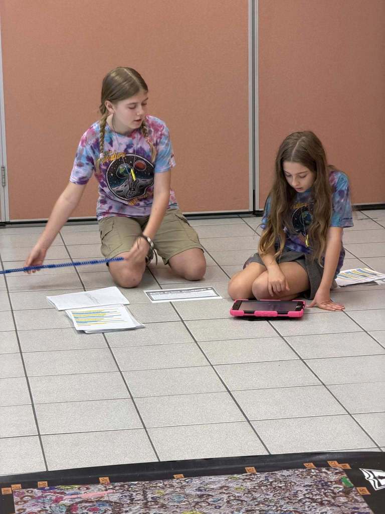 students working on their iPad during the competition