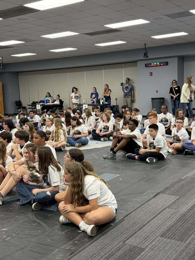 All participating students sitting on a huge map of the moon waiting for the awards presentation