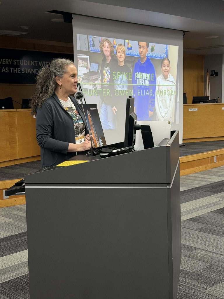 Katy Campbell speaking at the podium encouraging students