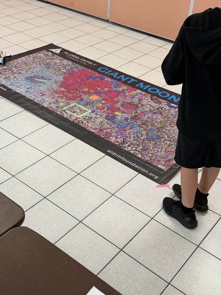 a map of the moon with a student presenting