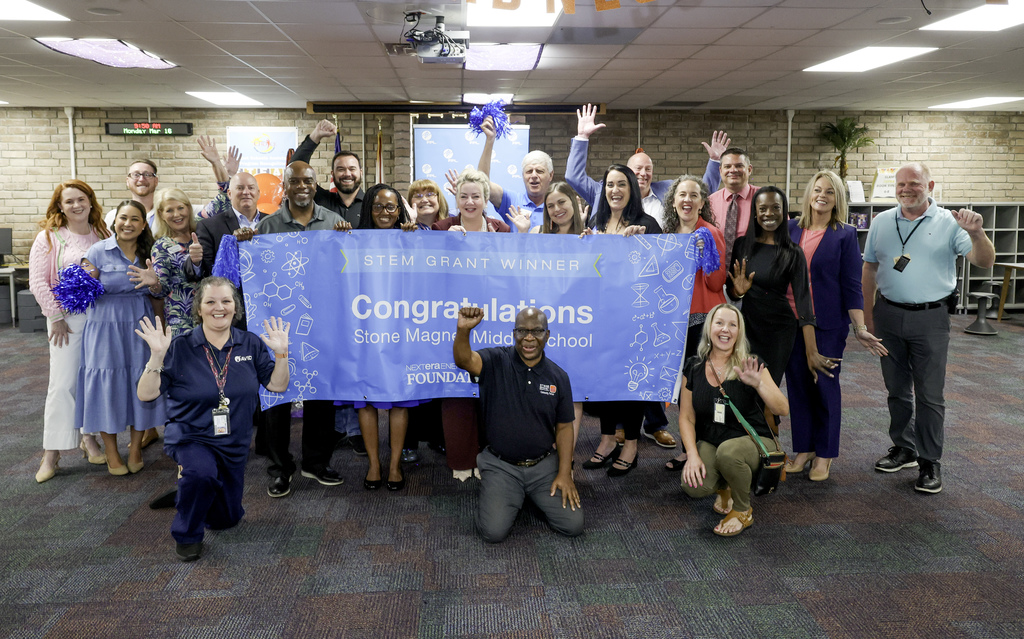 picture of people around the BPL grant congratulations sign