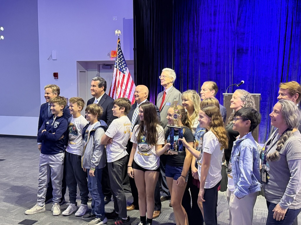 A group of students standing with their trophy