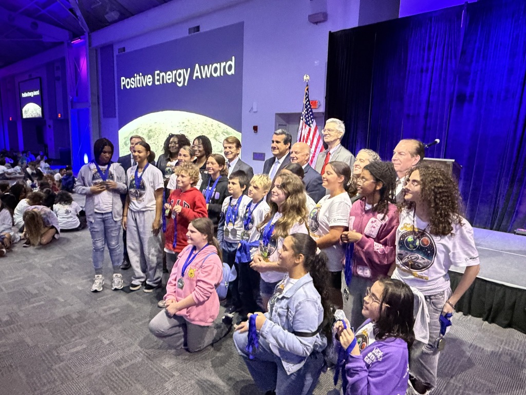 A group of students standing with their trophy
