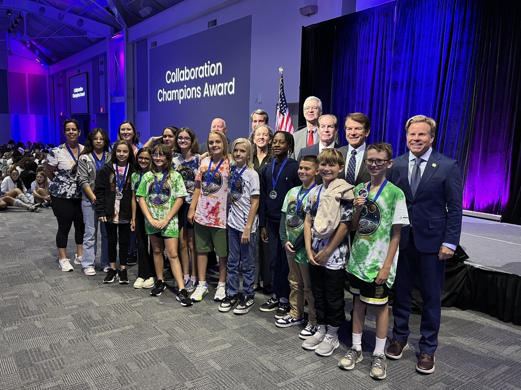 A group of students standing with their trophy